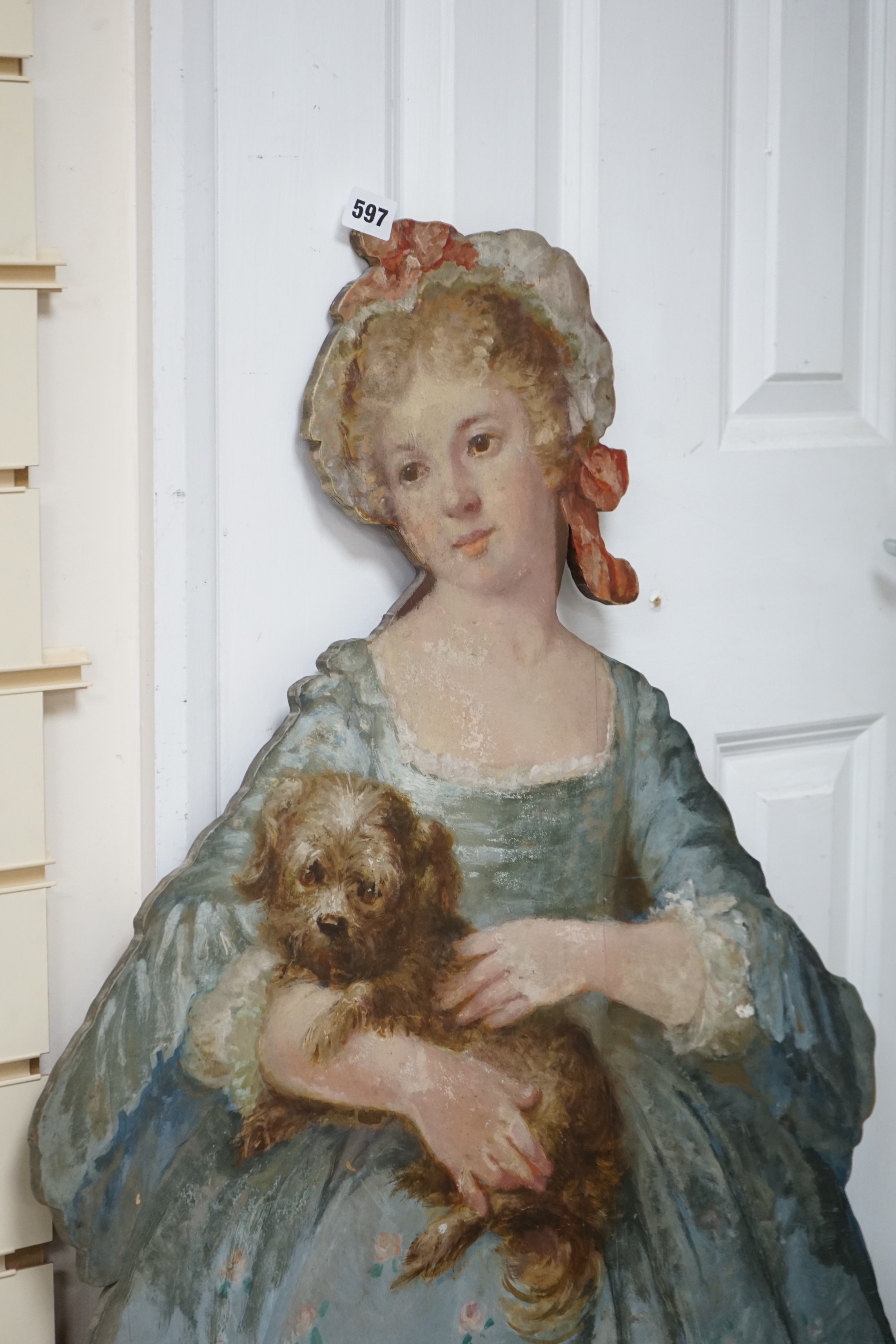 Two painted wood dummy boards, early 20th century, standing figure of a young girl holding a dog, in imitation of Pompeo Batoni (1708-1787), portrait of Countess Stanhope, 112cm tall, together with a smaller wood standin